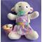 Measurements: 15" top of head to feet - 14.5" diameter. White lamb with pink ears, aqua ribbon, purple Easter holiday pinafore, rainbow ribbon at waist, and pink buckle with eggs at her side.