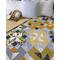 handmade quilt, 56 X 70, shades of yellow and gray; scrappy look with folk-themed prints mixed with solids and stripes; gender neutral