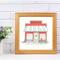 A watercolor and ink print of an old red wooden diner with a blue and white awning. Surfboards, a fishing pole, and a bike sit outside.