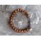 Rustic amber glass beaded bracelet with vintage brass heart charm
