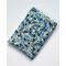 A padded book sleeve made with a blue floral Rifle Paper Co. cotton print called Garden Party Blue.