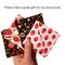 A hand holding 4 different corner bookmarks. Each are made with different fabrics. Two are florals and two are strawberry prints.