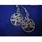 round dangle earrings with a rhinestone encrusted leaf pattern.