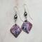 Purple and silver square dangles embossed with geometric shaped imprints hung with silver swarovski pearls. Handcrafted silver earring wires