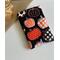 this pumpkin kindle sleeve has a black background with pumpkins having different prints on them