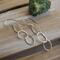 Fine silver triple hoop hammered finish dangle earrings with a sterling silver ear wire.