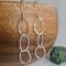 Fine silver triple hoop hammered finish dangle earrings with a sterling silver ear wire.