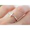Thin sterling silver ring with a sideways cross.