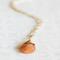 Sunstone necklace, orange briolette in 14K gold, on white background. 