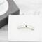 Sterling silver semicolon awareness ring with subtle symbol, on white surface supporting mental health and suicide prevention.
