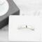 Sterling silver semicolon awareness ring with subtle symbol, on white surface, supporting mental health and suicide prevention.
