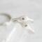  Two sterling silver stackable rings with lowercase initials "a," a heart,  on a white  background 