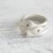  Three sterling silver stackable rings with lowercase initials "a," heart, and "t" on a white  background with dried flowers
