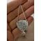 Sterling silver trillion shape imprinted with a mandala design hanging from sterling silver chain from two corners and a sterling ear wire. 