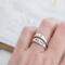 Hand with two sterling silver rings, "YOU SAY" and cross design.
