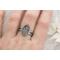 Handcrafted sterling silver wildflower ring on finger, featuring a unique floral design, set on a double wire band.

