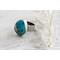 Sterling silver ring featuring chunky turquoise free form stone with silvery pyrite inclusions and a floral textured band.
