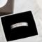 Sterling silver floral ring in a black and white gift box, highlighting its elegant packaging.
