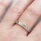  Close-up of a sterling silver floral textured ring on a finger, showcasing its 4mm floral design
