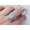 Sterling silver ring band featuring a oblong sea green/blue Chalcedony stone in a sterling silver bezel.
