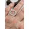Sterling silver ring with an open circle top, lightly hammered textured finish. 