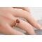 Pear shaped Baltic amber cabochon set on a textured organic band and bezel.