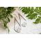 Trillion shaped sterling silver earrings stamped with a floral design hanging from sterling silver chain a French hook ear wire. 