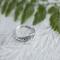 Close-up of vintage sterling silver leaf ring on white wood, eco-friendly, sizes 3-10.  
