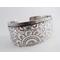 Wide sterling silver bracelet with floral textured overlay.
