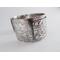 Wide sterling silver bracelet with floral textured overlay.