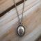 Handcrafted sterling silver lotus flower yoga necklace on wooden background, 16"-20" chain, unique gift design.
