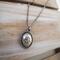 Handcrafted sterling silver lotus flower yoga necklace on wooden background, 16"-20" chain, unique gift design.
