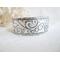 Wide sterling silver cuff bracelet with layered scrollwork pattern. 
