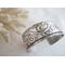 Wide sterling silver cuff bracelet with layered scrollwork pattern. 