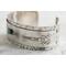 Sterling silver cuff bracelet with embossed arrow overlay accented with a genuine turquoise cabochon. 