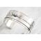 Sterling silver cuff bracelet with embossed arrow overlay accented with a genuine turquoise cabochon. 