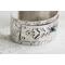 Sterling silver cuff bracelet with embossed arrow overlay accented with a genuine turquoise cabochon. 