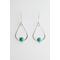 Two sterling silver teardrop-shaped earrings, each featuring a turquoise gemstone set in a detailed bezel on a white backdrop. 