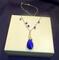 Image is of a Blue Crystal Teardrop Pendant wire wrapped on a chain. Blue Swarovski Crystals are wire wrapped onto the chain.  19" long