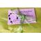 Image of tissue paper wrapping and a bow and a business card for a jewelry order.