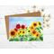 This is a greeting card from a hand painted watercolor of different colored sunflowers of red orange and yellow.