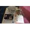 Photo is of packaging including jewelry, tissue paper, business card and a coupon card. 