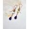 Earrings with yellow opal on wire and deep purple wire wrapped amethyst briolette dangles. On handcrafted copper earring wires.