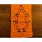 Close-up of an orange scarf showing details of a leaf in the pattern.