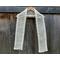 Display of the Diagonal Crochet Scarf Pattern on a hanger in front of a wooden fence.
