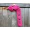 Another pic of a pink scarf with the letters MOM along its length.