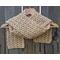 A tan shell crochet scarf display.