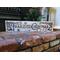 A handmade Christmas sign decorated a fireplace hearth.