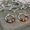 Progress pride chainmaille hoop earrings with 22 tiny links; two links in each of the 11 colors of the rainbow progress pride flag