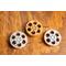 top view of a three miniature movie reel magnet in gold and silver sitting on a wooden table